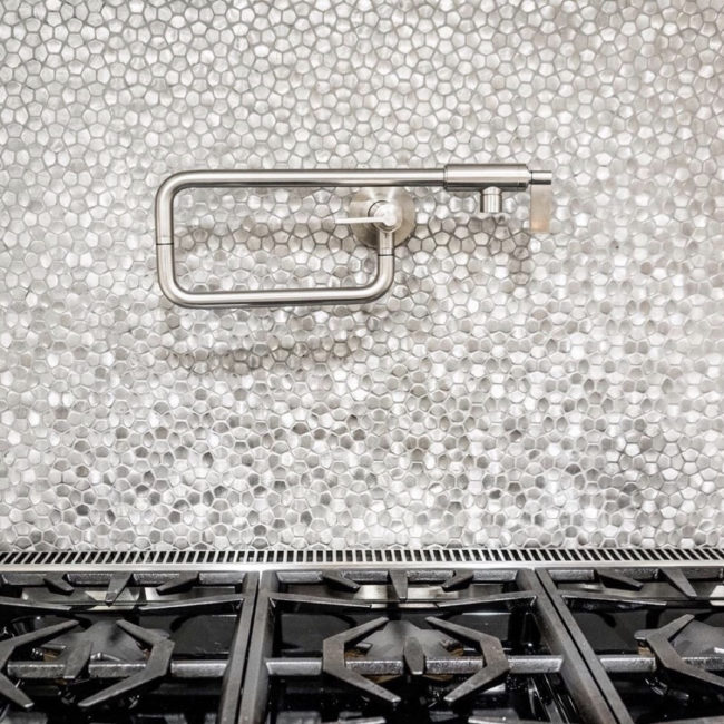 silver metal mosaic tile on kitchen backsplash over stove