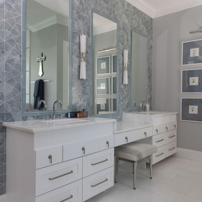 blue glass hexagon tiled backsplash with white vanity in residential bathroom 